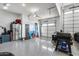 Clean three-car garage with epoxy floors and organized storage solutions for a clutter-free space at 7694 W Desert Spoon Dr, Peoria, AZ 85383