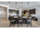 Beautiful kitchen island featuring barstool seating, pendant lighting, and modern appliances, with white countertops at 7694 W Desert Spoon Dr, Peoria, AZ 85383