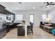 Modern kitchen with dark cabinets, a large island with seating, and an open layout connecting to the living area at 7694 W Desert Spoon Dr, Peoria, AZ 85383