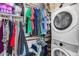Functional laundry room with a washer, dryer, and ample storage shelves for organization and convenience at 7694 W Desert Spoon Dr, Peoria, AZ 85383