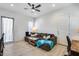 Cozy living room featuring tile floors, a comfortable sectional sofa, and ample natural light, creating a relaxing space at 7694 W Desert Spoon Dr, Peoria, AZ 85383