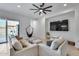 Bright living room featuring a hanging chair, large windows, and modern furnishings at 7694 W Desert Spoon Dr, Peoria, AZ 85383
