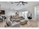 Relaxing living room adjacent to dining area with sliding glass doors and modern furniture at 7694 W Desert Spoon Dr, Peoria, AZ 85383