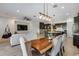Open-concept living room with modern furnishings, dining area, and kitchen view at 7694 W Desert Spoon Dr, Peoria, AZ 85383