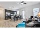 Open-concept living space features a kitchen with island seating and a comfortable living area with a gray sofa at 7694 W Desert Spoon Dr, Peoria, AZ 85383