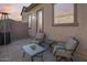 Inviting outdoor patio space with comfortable seating, a heater, and paver flooring, perfect for relaxing evenings at 7694 W Desert Spoon Dr, Peoria, AZ 85383