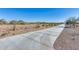 Concrete walking path near desert landscaping with mountain views in the distance under a clear blue sky at 7694 W Desert Spoon Dr, Peoria, AZ 85383