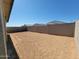 Large dirt backyard, surrounded by block wall fencing, offering privacy and customizable outdoor space at 8577 W Trenton Ct, Florence, AZ 85132