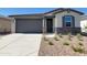 Charming single-story home featuring a stone facade, neutral color palette, and well-manicured desert landscaping at 8577 W Trenton Ct, Florence, AZ 85132