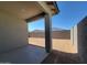 A covered patio looks out to a spacious dirt backyard with block fencing, providing privacy and outdoor opportunities at 8577 W Trenton Ct, Florence, AZ 85132