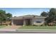 Charming single-story home with stone accents, a two-car garage and a neatly landscaped front yard at 870 W Peralta Pass, Apache Junction, AZ 85120