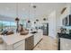 Bright, open-concept kitchen with stainless appliances and large island with dining area at 870 W Peralta Pass, Apache Junction, AZ 85120