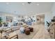 Open-concept living room with a cozy couch, access to the kitchen and lots of natural light at 870 W Peralta Pass, Apache Junction, AZ 85120