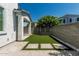 Private backyard features artificial turf, pavers, gravel beds, and block wall for a serene outdoor space at 905 S Canal Dr # 17, Chandler, AZ 85225