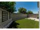 Low maintenance backyard with artificial turf, block wall, rock details and mature trees create a relaxing outdoor space at 905 S Canal Dr # 17, Chandler, AZ 85225