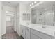 Bright bathroom featuring double sink vanity, large mirror, and glass-enclosed shower at 905 S Canal Dr # 17, Chandler, AZ 85225