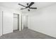 This bedroom features a ceiling fan, closet, and bright, neutral walls at 905 S Canal Dr # 17, Chandler, AZ 85225
