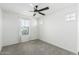 Sunny bedroom with carpet, ceiling fan, and a large window at 905 S Canal Dr # 17, Chandler, AZ 85225