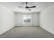 Bright bedroom with plush carpeting, ceiling fan, and natural light from the window at 905 S Canal Dr # 17, Chandler, AZ 85225