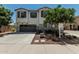 Two-story home with a gray garage door, landscaping, and a concrete driveway at 905 S Canal Dr # 17, Chandler, AZ 85225
