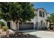 Exterior view of home showcasing the garage, stucco detail and landscaping at 905 S Canal Dr # 17, Chandler, AZ 85225