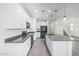Spacious kitchen with stainless steel appliances, white cabinets, gray countertops and hardwood floors at 905 S Canal Dr # 17, Chandler, AZ 85225
