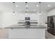 A modern kitchen with stainless steel appliances, an island and white cabinetry at 905 S Canal Dr # 17, Chandler, AZ 85225
