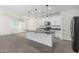 Modern kitchen featuring white cabinets, island, stainless steel appliances and gray countertop at 905 S Canal Dr # 17, Chandler, AZ 85225