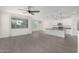 Open concept living room and kitchen space with windows, hardwood floors and a ceiling fan at 905 S Canal Dr # 17, Chandler, AZ 85225