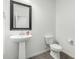 Clean powder room featuring pedestal sink, dark mirror, and tiled floors at 905 S Canal Dr # 17, Chandler, AZ 85225