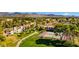 Overhead shot highlighting lush green spaces, tennis courts, and community pathways, complemented by a picturesque mountain backdrop at 9450 N 94Th Pl # 205, Scottsdale, AZ 85258