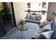 Balcony features comfy seating, decorative plants, geometric rug, and wood table at 9450 N 94Th Pl # 205, Scottsdale, AZ 85258