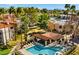 Community pool with lounge area surrounded by palm trees and lush landscaping at 9450 N 94Th Pl # 205, Scottsdale, AZ 85258