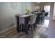 Dining area with table and chairs, modern decorations, mirror accent wall, and wood-style flooring at 9450 N 94Th Pl # 205, Scottsdale, AZ 85258