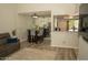 Cozy living room features modern wood flooring, a comfortable couch, and an adjacent dining area with bar stool seating at 9450 N 94Th Pl # 205, Scottsdale, AZ 85258