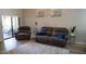 Living area with comfortable sofa, recliner, modern decor, and sliding glass doors to a balcony with patio seating at 9450 N 94Th Pl # 205, Scottsdale, AZ 85258