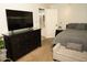 Main bedroom featuring a dresser with a tv next to a king size bed at 9450 N 94Th Pl # 205, Scottsdale, AZ 85258