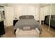 Main bedroom with walk in closet. King size bed with neutral colored bedding at 9450 N 94Th Pl # 205, Scottsdale, AZ 85258