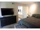 Main bedroom with dresser and TV across from the bed. Bathroom door visible at 9450 N 94Th Pl # 205, Scottsdale, AZ 85258
