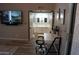Well lit home office with desk, TV, and access to an ensuite bathroom featuring a double sink vanity at 9450 N 94Th Pl # 205, Scottsdale, AZ 85258