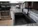 The kitchen features a black sink with modern faucet, stainless steel appliances, and updated countertops at 9450 N 94Th Pl # 205, Scottsdale, AZ 85258