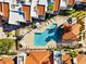 Aerial shot of a community swimming pool with lounge chairs, umbrellas, and lush landscaping, creating a resort-like atmosphere at 9450 N 94Th Pl # 205, Scottsdale, AZ 85258