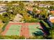 Aerial view of well-maintained tennis courts with lush landscaping and mature palm trees surrounding the community at 9450 N 94Th Pl # 205, Scottsdale, AZ 85258