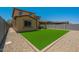 Well-maintained backyard featuring lush artificial grass, gravel, and ample space for outdoor activities at 9752 E Torino Ave, Mesa, AZ 85212