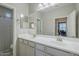 Bathroom with a double sink vanity, large mirror, and neutral color scheme at 9752 E Torino Ave, Mesa, AZ 85212