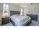 Bright bedroom features a king-size bed, bedside tables, and dresser, illuminated by natural light at 9752 E Torino Ave, Mesa, AZ 85212