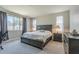 Bedroom with a large bed, neutral carpet, and natural light from windows at 9752 E Torino Ave, Mesa, AZ 85212