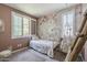 Cozy bedroom with decorative wallpaper, shuttered windows, and stylish furniture at 9752 E Torino Ave, Mesa, AZ 85212