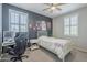 Cozy bedroom with a single bed, desk area, and unique wall art creates a personalized space at 9752 E Torino Ave, Mesa, AZ 85212
