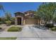 Charming home features a stone accent entry, a two-car garage, and well-maintained landscaping at 9752 E Torino Ave, Mesa, AZ 85212